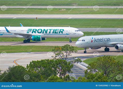 Frontier and American Airlines Aircraft on Runway Preparing for ...