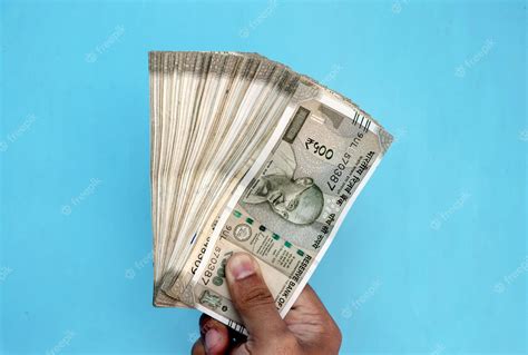 Premium Photo | Man Hand holding Rupees 500 bank note savings