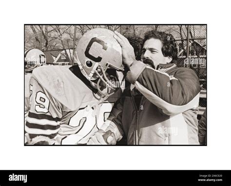 A coach of the Canarsie high school football team congratulates a ...