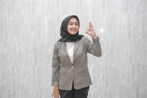 The happy expression of an asian indonesian hijabwearing woman wearing ...