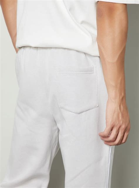 Buy Men Solid Trousers with Snap Button Hem Online at just Rs. 1399.0 ...