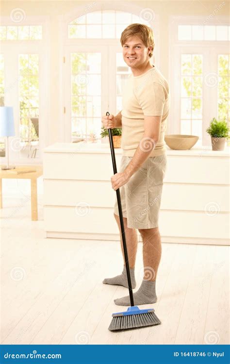 Guy sweeping the floor stock photo. Image of clothing - 16418746
