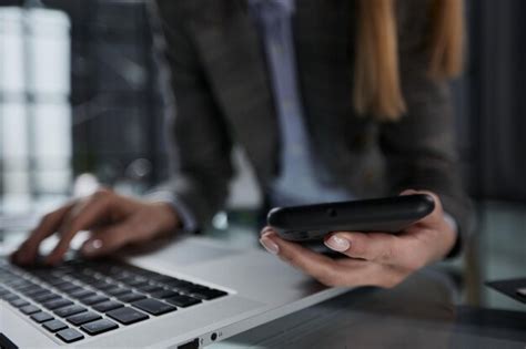 Close up hand using phone screen on workspace table | Premium Photo