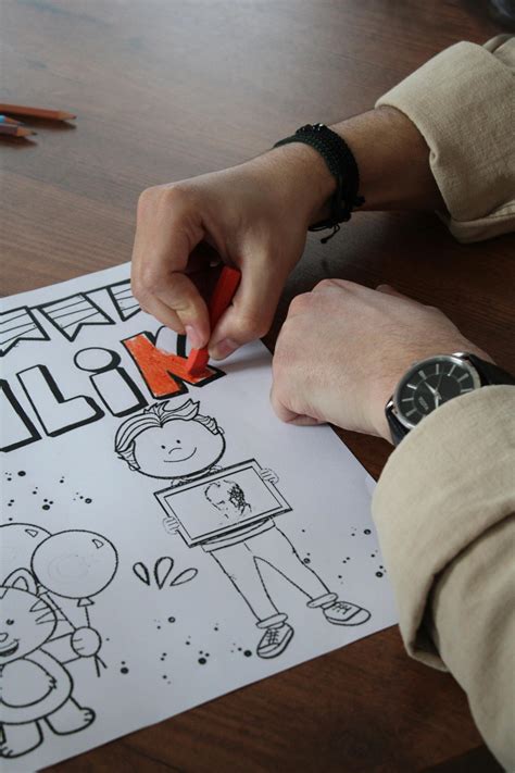 Close-up of Hand Coloring Drawing on Table · Free Stock Photo