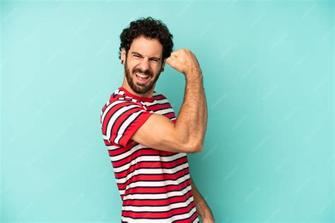 Feeling happy satisfied and powerful flexing fit and muscular biceps ...