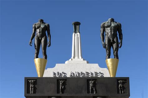 The "Olympic Gateway" arch and male and female statues at the entrance ...