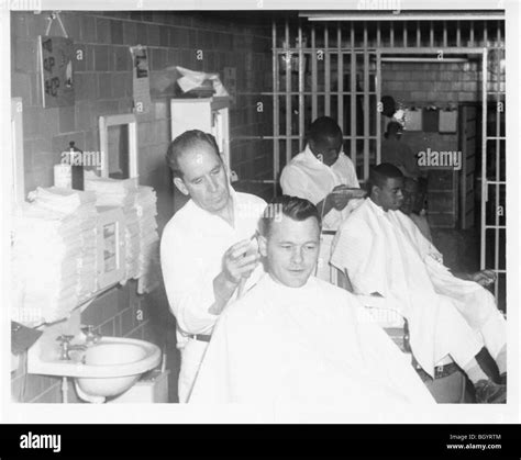 Inmate giving a member of the staff a haircut. Metal scissors and ...