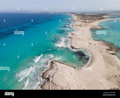 Aerial view of Ibiza, Spanish coast with white foamy waves on the ...