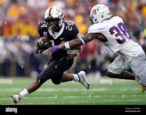 Minnesota running back Mohamed Ibrahim is tackled by Western Illinois ...