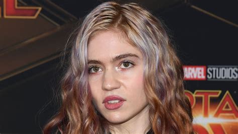 Grimes debuts a new face tattoo but is met with brutal feedback comparing it to fungus