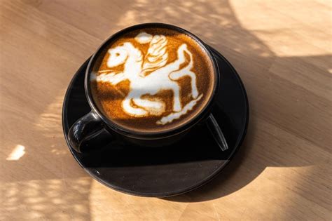 Hot coffee latte with latte art in the form of a horse milk foam in cup ...