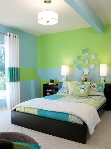 blue green bedding set on the black wooden low profile bed between ...