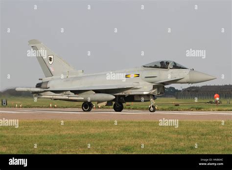 Royal Air Force ground crew preparing an RAF Typhoon fighter jet. It is night-time and the team are