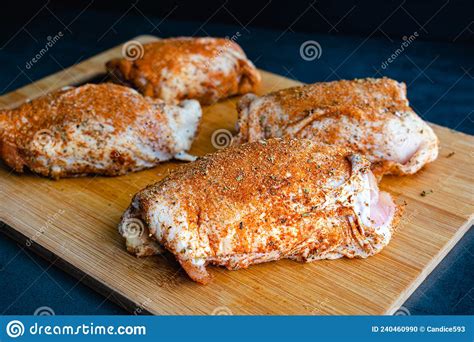 Bone-in Skin-on Raw Chicken Thighs Rubbed with Spice Mixture Stock ...