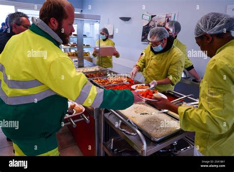 Disabled workers preparing meals for users and supervisors of the ESAT ...