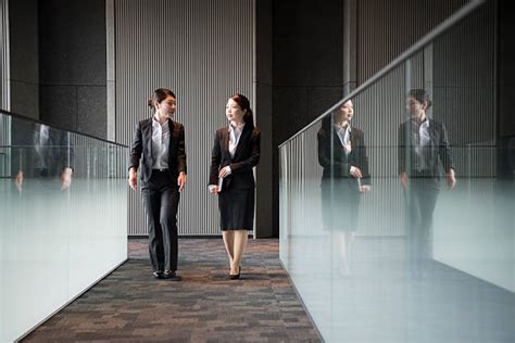 Two Business People Walking Side by Side 的图像结果