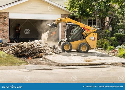 Bobcat Machine is Removing Concrete Floor from Garage for Renovation ...