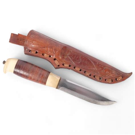 A Norwegian hunting knife, with bone walnut turned handle, blade marked ...