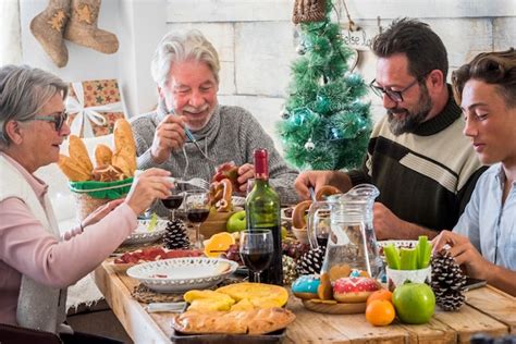 Caucasian people have fun in christmas lunch at home | Premium Photo