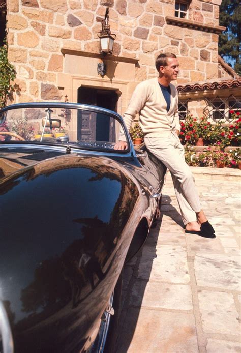 Steve McQueen posing for a portrait with his Jaguar XKSS at his home on ...