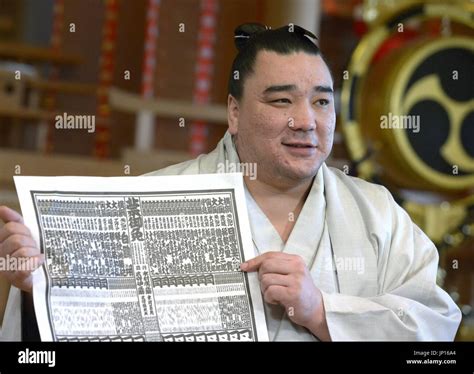 OSAKA, Japan - Yokozuna Harumafuji points to his name on a new sumo rankings list in Osaka on ...