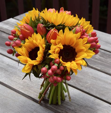 Hand-tied bouquet of sunflowers, tulips and hypericum berries ...