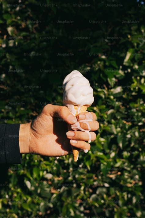 A person is holding a small ice cream cone in their hand photo – Humour ...