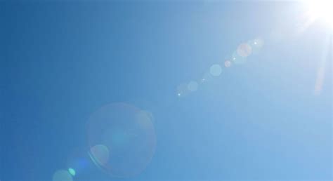 Blue sky with sun and lens flare | AI-generated image