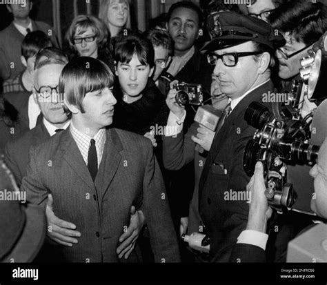 Ringo Starr, the Beatles' drummer, is escorted through crowd as he ...