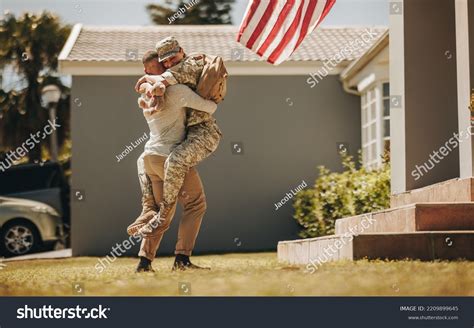 Joyful Military Homecoming Cheerful Soldier Embracing Stock Photo ...