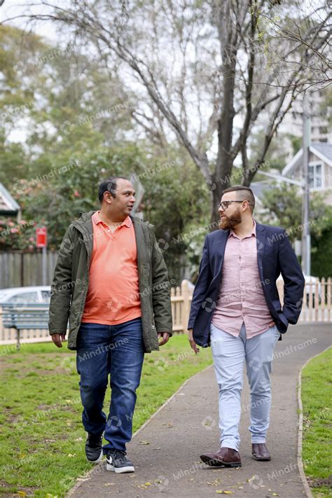 Two people talking and walking outside in park - Mindframe online image ...