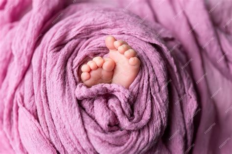 Premium Photo | Legs of a newborn baby babys feet baby feet on purple ...