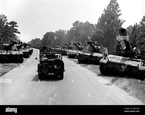 Secretary of Defense Caspar W. Weinberger is taken by jeep to tour the ...