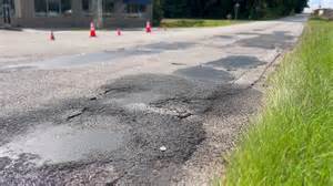 Potholes, cracks, blind spots on road near I-26 leave neighbors frustrated