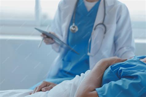 Injured patient showing doctor broken wrist and arm with bandage in ...