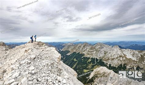 Hiker at the summit of the eastern Ödkarspitze, view of the Karwendel ...