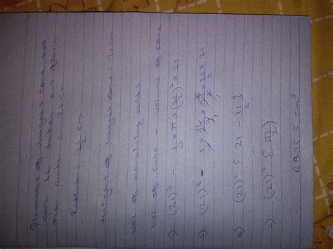 the largest cone is curved out from one face of solid cube of side 21 ...
