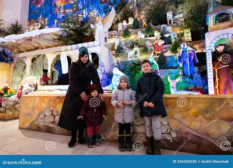 Mother with Three Children Visit Christmas Nativity Crib Scene in ...