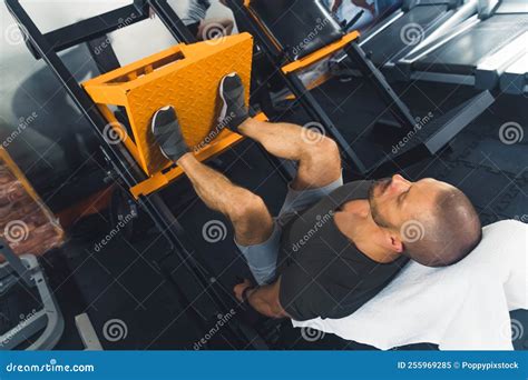 Full Shot of a Young Muscular Man Doing Leg Press Exercises at the Gym ...