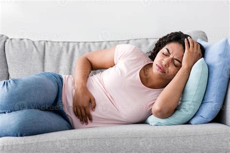 Feeling unwell, menstruation, flu, migraines and illness, covid-19 at home. Sad despair young ...