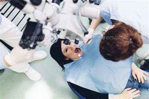 Dentist carrying out dental procedure on male patient, close-up
