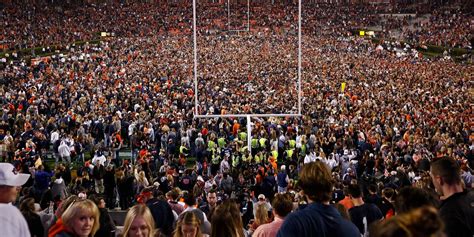 Fans head back to stadiums, some with vax cards and masks