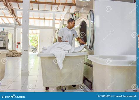 Staff in Uniform Washing Bed Sheet in Washing Machine Editorial Image ...