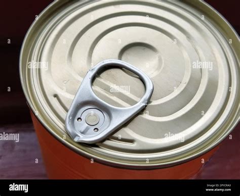 canned food lid with a bottle opener. Hook metal can top for easy opening Stock Photo - Alamy