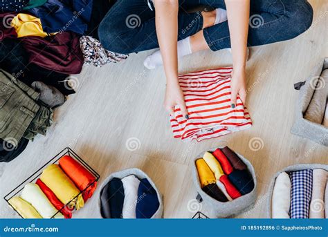 Woman Folding Pile of Clothes on the Floor, Organizing Stuff Stock ...