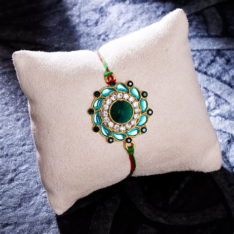 Sukkhi Attractive Gold Plated Floral Rakhi with Roli Chawal and Raksha ...