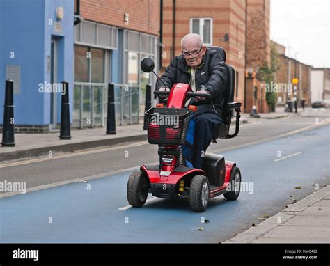 Old man on mobility scooter hi-res stock photography and images - Alamy