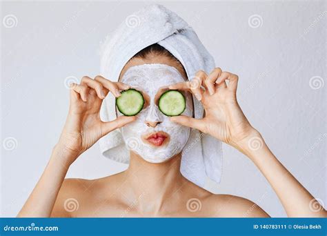 Beautiful Young Woman with Facial Mask on Her Face Holding Slices of ...