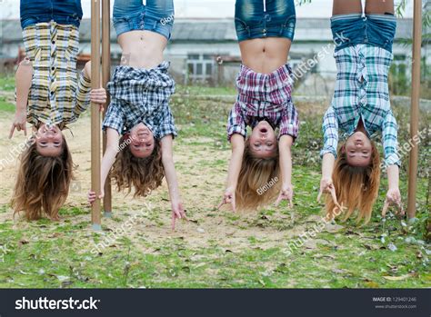 Four Young Girls Hanging Upside Down: foto de stock (editar ahora) 129401246