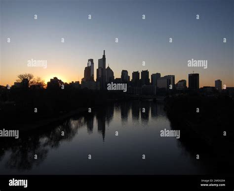 The Philadelphia skyline is seen silhouetted against the sunrise over ...